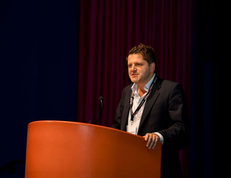 Speaker at the podium at StratFest 2025.