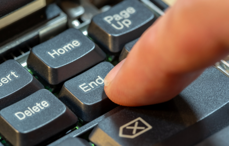 Finger pressing an End key on a keyboard.