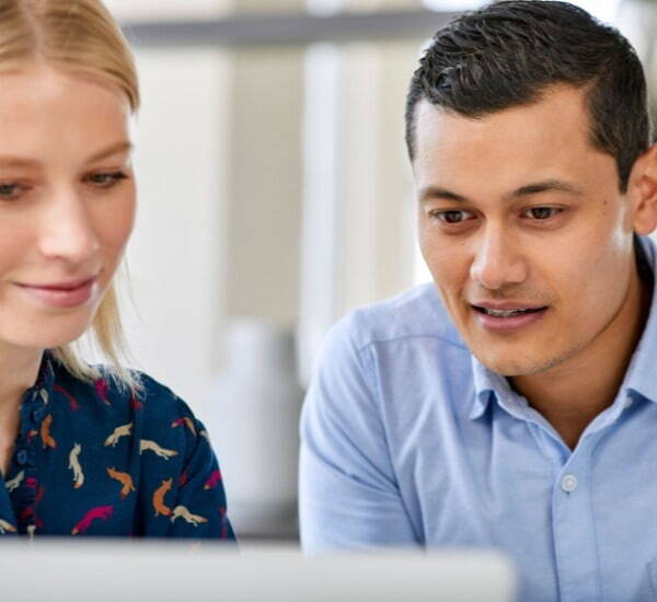 Two people looking at laptop